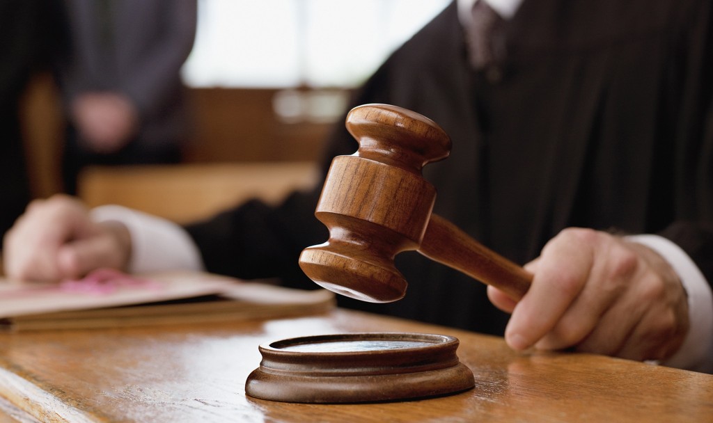 Judge holding gavel in courtroom